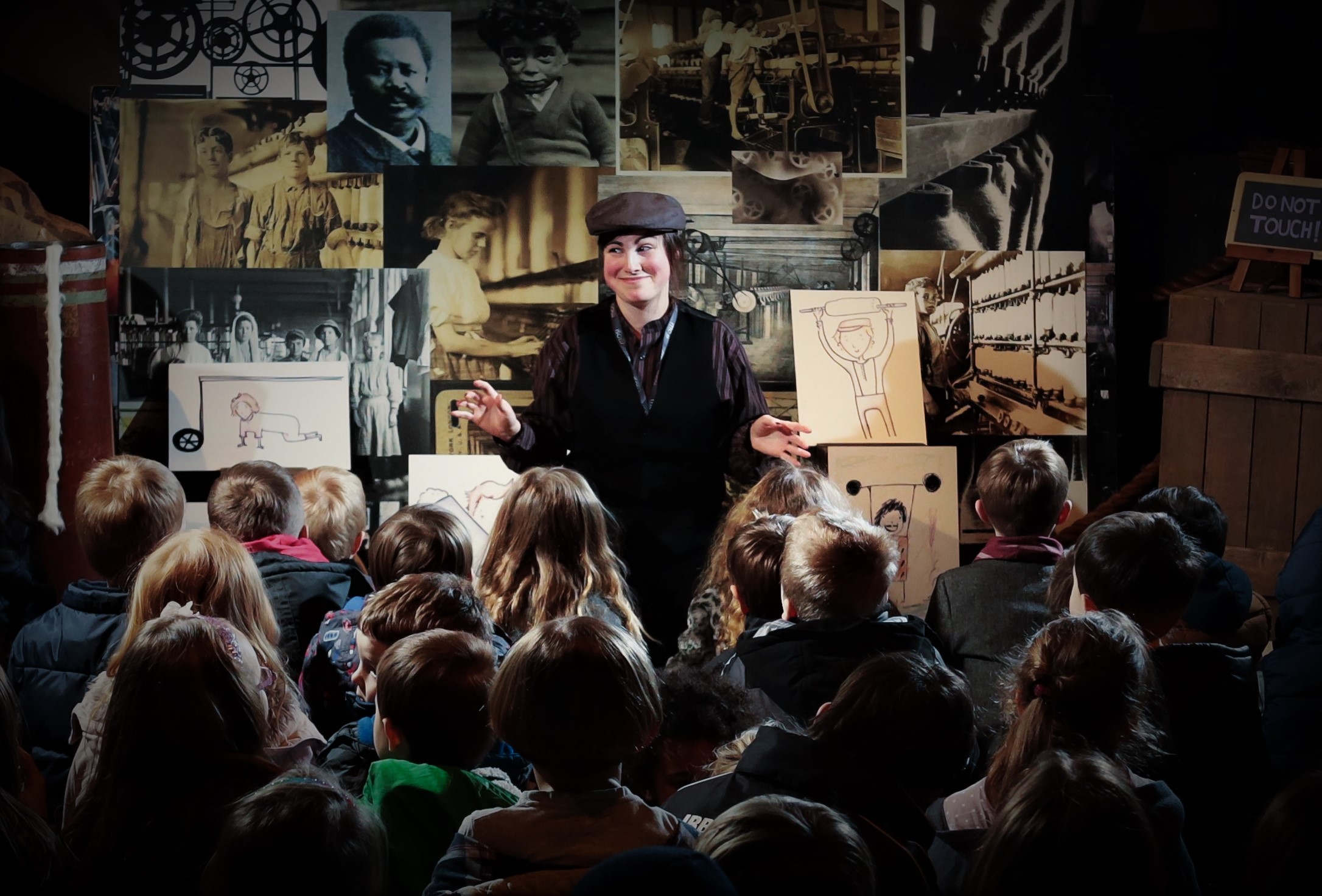 a woman presenting to a crowd of children